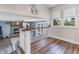 Upper loft view of a living room with brick fireplace and open floor plan, featuring hard wood floors at 6288 Buttonwood Dr, Noblesville, IN 46062