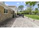 Paver patio with stone wall, hot tub, grill, and backyard beyond creates a wonderful outdoor living space at 6288 Buttonwood Dr, Noblesville, IN 46062