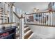 Staircase with wood steps and white railings leading to the upper level of the home at 6288 Buttonwood Dr, Noblesville, IN 46062