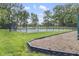 Community tennis courts with a black chain link fence and a backdrop of trees and greenery at 6288 Buttonwood Dr, Noblesville, IN 46062