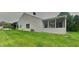 This home has a spacious backyard with a screened-in porch and a lush green lawn at 7018 Mallard Way, Plainfield, IN 46168