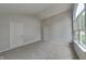 This is a bedroom with neutral gray paint, plush carpet, and a large window for plenty of natural light at 7018 Mallard Way, Plainfield, IN 46168