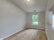 Bright bedroom features a window and neutral walls complemented by wood-look floors at 7018 Mallard Way, Plainfield, IN 46168