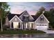 Charming home features a two-car garage, stone accents, dormer windows, and beautiful landscaping at 7032 Portico Ln, McCordsville, IN 46055