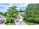 A high angle view showcases a brick home with mature trees and attached two-car garage at 7110 Koldyke Dr, Fishers, IN 46038