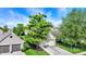 An aerial view of a home showcasing the mature trees and landscape with a two-car garage at 7110 Koldyke Dr, Fishers, IN 46038