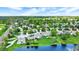 Aerial view showcases a lakeside neighborhood, highlighting the homes surrounded by green lawns and mature trees at 7110 Koldyke Dr, Fishers, IN 46038