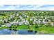 Aerial shot of a residential area featuring houses, trees, a pond, and a golf course at 7110 Koldyke Dr, Fishers, IN 46038