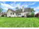 Spacious backyard with lush lawn and patio featuring outdoor dining set and landscaping at 7110 Koldyke Dr, Fishers, IN 46038