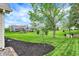 Large backyard featuring lush green grass and mature trees with privacy at 7110 Koldyke Dr, Fishers, IN 46038