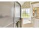 Well-lit bathroom featuring a glass enclosed shower and a soaking tub near the window at 7110 Koldyke Dr, Fishers, IN 46038