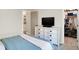 Comfortable bedroom with a large window providing natural light, a dresser and closet at 7110 Koldyke Dr, Fishers, IN 46038