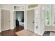 Bright foyer featuring hardwood floors, neutral paint, and a view into adjacent living spaces at 7110 Koldyke Dr, Fishers, IN 46038