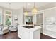 Beautiful eat-in kitchen featuring an island cooktop, stainless appliances, and hardwood floors at 7110 Koldyke Dr, Fishers, IN 46038