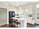 Bright kitchen with white cabinetry, modern island with seating and stainless steel appliances at 7110 Koldyke Dr, Fishers, IN 46038