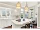 Bright eat-in kitchen with white cabinets, an island cooktop, and stainless steel appliances at 7110 Koldyke Dr, Fishers, IN 46038