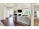Bright and spacious living room featuring hardwood floors, a fireplace, and large windows with natural light at 7110 Koldyke Dr, Fishers, IN 46038