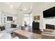 Bright living room with neutral colored sofa, fireplace, and open to kitchen area at 7110 Koldyke Dr, Fishers, IN 46038