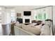 Bright living room with neutral colored sofa, lots of seating and fireplace at 7110 Koldyke Dr, Fishers, IN 46038