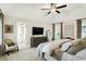 Spacious main bedroom featuring a ceiling fan, carpeted floors, and an ensuite bathroom at 7110 Koldyke Dr, Fishers, IN 46038
