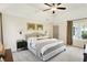 Comfortable main bedroom featuring high ceilings, a cozy bed, and neutral walls at 7110 Koldyke Dr, Fishers, IN 46038