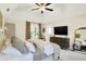 Bright and airy bedroom featuring high ceilings, cozy furniture, and a nearby ensuite bathroom at 7110 Koldyke Dr, Fishers, IN 46038