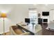 Bright office space with a modern desk, neutral colors and open to living space at 7110 Koldyke Dr, Fishers, IN 46038
