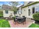 Cozy brick patio with outdoor dining set and a decorative fountain in the landscaped yard at 7110 Koldyke Dr, Fishers, IN 46038