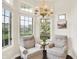 Cozy sitting area featuring a window-lined nook, hardwood floors, and comfortable armchairs at 7110 Koldyke Dr, Fishers, IN 46038