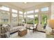 Bright sunroom with lots of windows and a comfortable seating area at 7110 Koldyke Dr, Fishers, IN 46038