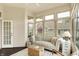 Bright sunroom with comfortable seating, ceiling fan, and lots of windows for natural light at 7110 Koldyke Dr, Fishers, IN 46038