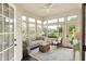 Bright sunroom with comfortable seating, ceiling fan, and lots of windows for natural light at 7110 Koldyke Dr, Fishers, IN 46038