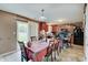 A dining room with a table set for eight and sliding glass doors leading to the backyard at 7303 Beal Ln, Indianapolis, IN 46217