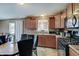Kitchen featuring updated appliances, wooden cabinetry, and direct access to the backyard at 7303 Beal Ln, Indianapolis, IN 46217