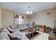 The room features neutral-toned walls, carpet flooring, and a large sectional sofa at 7303 Beal Ln, Indianapolis, IN 46217
