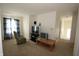 Upstairs living room area featuring simple furnishings and neutral colored carpet at 7303 Beal Ln, Indianapolis, IN 46217