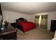 Spacious main bedroom featuring neutral walls, dark furniture, and decorative curtains at 7303 Beal Ln, Indianapolis, IN 46217