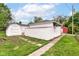 This backyard features a walkway, grass, fence, shed, and garage at 736 N Dequincy St, Indianapolis, IN 46201