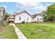 This backyard features a walkway, grass, fence, and home exterior at 736 N Dequincy St, Indianapolis, IN 46201