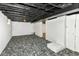 Unfinished basement featuring concrete walls, exposed ceiling, and carpet at 736 N Dequincy St, Indianapolis, IN 46201
