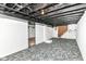 Unfinished basement featuring concrete walls, exposed ceiling, and carpet at 736 N Dequincy St, Indianapolis, IN 46201