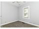 This bedroom features neutral walls, a window with blinds, carpet, and a ceiling fan at 736 N Dequincy St, Indianapolis, IN 46201