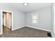 Cozy bedroom features soft carpet, neutral walls, and natural light from a window at 736 N Dequincy St, Indianapolis, IN 46201