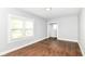Bright bedroom featuring hardwood floors, two large windows, and fresh paint, offering a serene and comfortable retreat at 736 N Dequincy St, Indianapolis, IN 46201