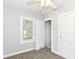 This bedroom includes neutral walls, closet, window with blinds, and ceiling fan at 736 N Dequincy St, Indianapolis, IN 46201