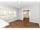 Bright dining room featuring wood flooring, large windows, and neutral wall color at 736 N Dequincy St, Indianapolis, IN 46201