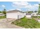 This backyard features a walkway, grass, fence, and detached garage at 736 N Dequincy St, Indianapolis, IN 46201
