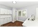 Modern kitchen showcasing white cabinets, quartz countertops, and stainless steel sink, creating a bright and inviting cooking space at 736 N Dequincy St, Indianapolis, IN 46201