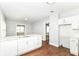 An open concept kitchen with white cabinets, countertops, and modern fixtures at 736 N Dequincy St, Indianapolis, IN 46201