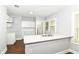 Well-lit kitchen with white cabinets, quartz countertops, and modern fixtures, designed for culinary enthusiasts and entertaining at 736 N Dequincy St, Indianapolis, IN 46201